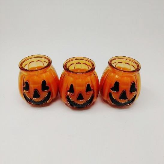 Pumpkin shaped glass candle